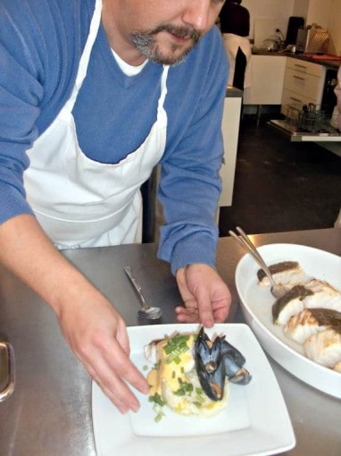 plating up food in cooking class in belgium