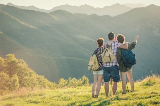 Friends traveling together looking at mountain.