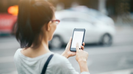woman using budget friendly app on smart phone