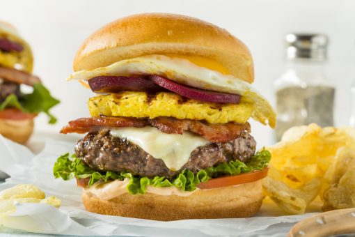 Think of a normal burger, and then fill it with pineapple, pickled beetroot, onion, cheese, bacon, and even a fried egg. Welcome to the Aussie burger with the lot. 