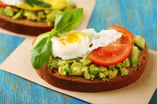Avocados on toast combined with goat cheese or feta, pepper, olive oil, and a poached egg. 