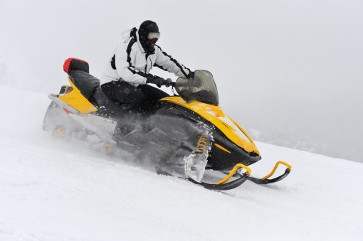 Man on snowmobile in winter mountain